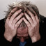 man holding head in frustration